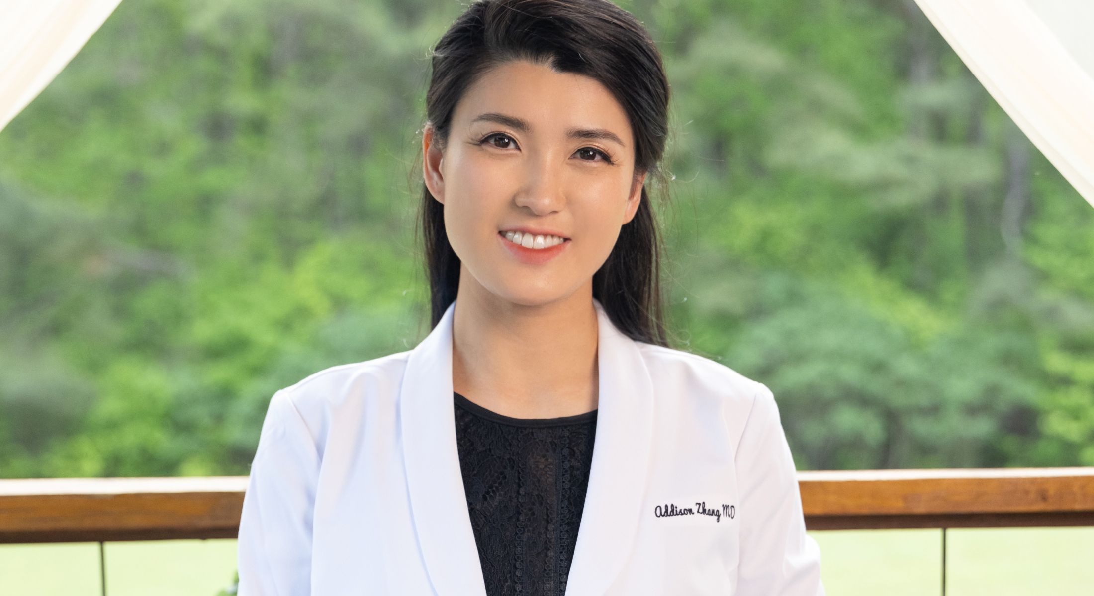 dr. addison standing in her white coat smiiling